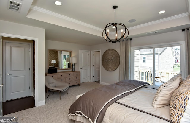 bedroom with an inviting chandelier, a tray ceiling, access to outside, carpet, and ornamental molding