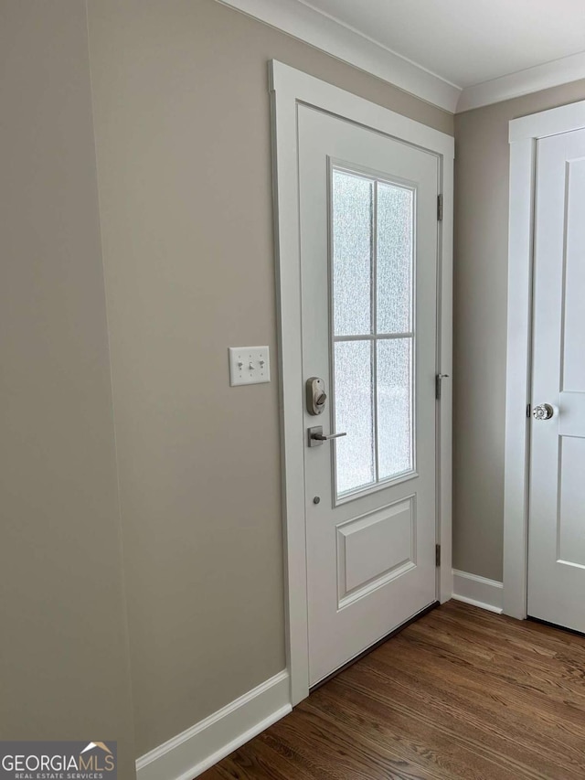 entryway featuring hardwood / wood-style flooring and ornamental molding