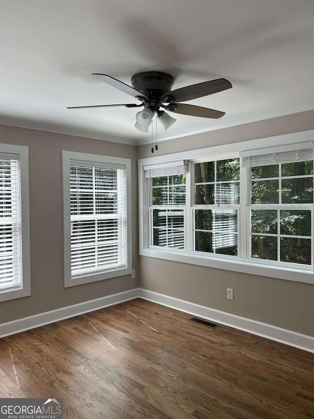 unfurnished room featuring ceiling fan and dark hardwood / wood-style flooring