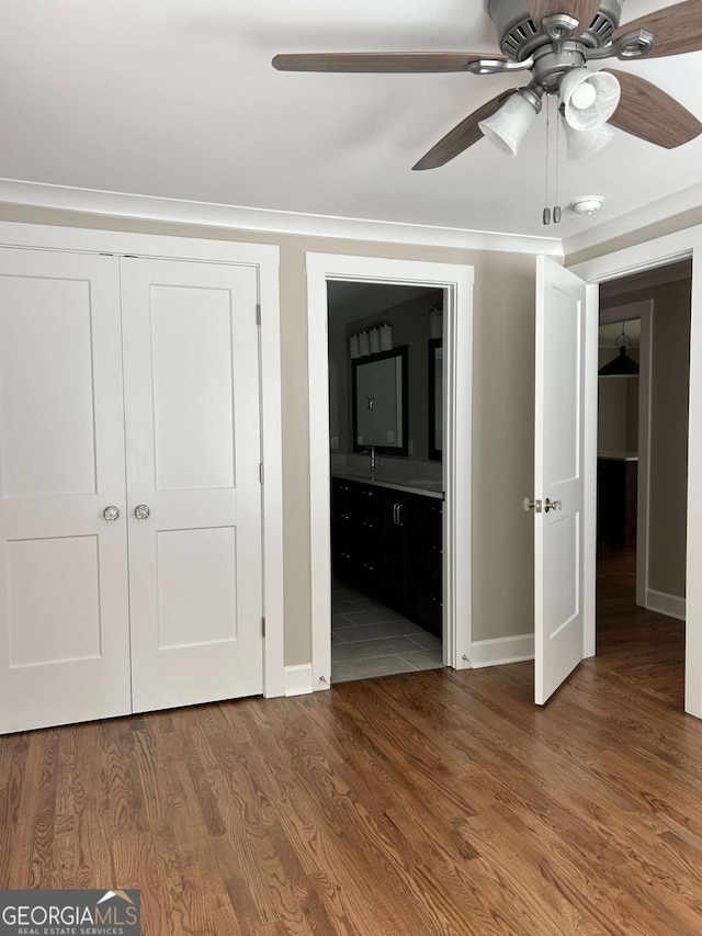 unfurnished bedroom with ceiling fan and hardwood / wood-style flooring