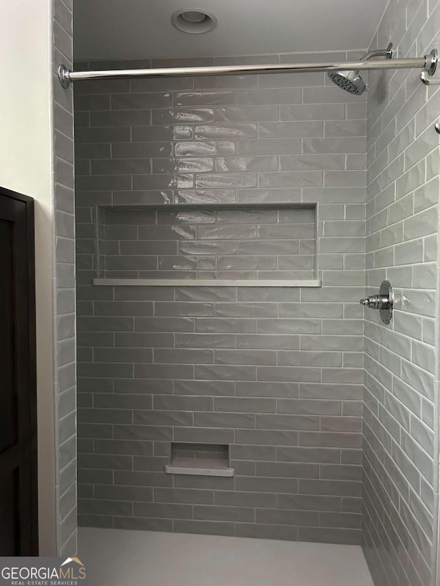 bathroom with a tile shower