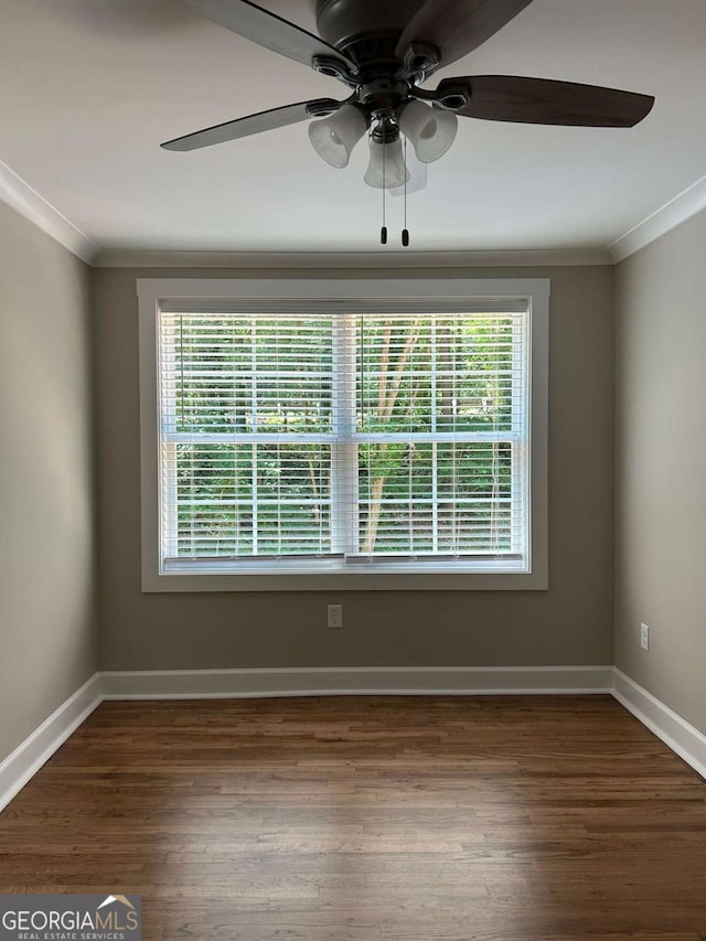 empty room with crown molding, ceiling fan, and dark hardwood / wood-style floors