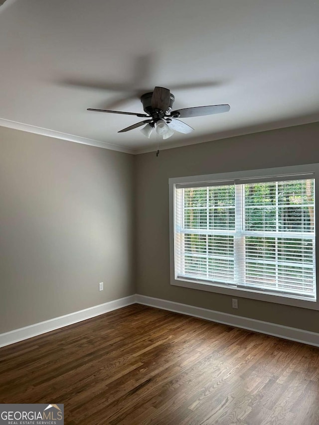 spare room with ceiling fan, dark hardwood / wood-style floors, and ornamental molding