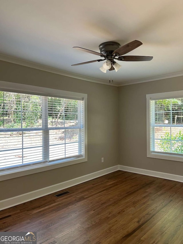 unfurnished room featuring dark hardwood / wood-style floors, ceiling fan, and ornamental molding