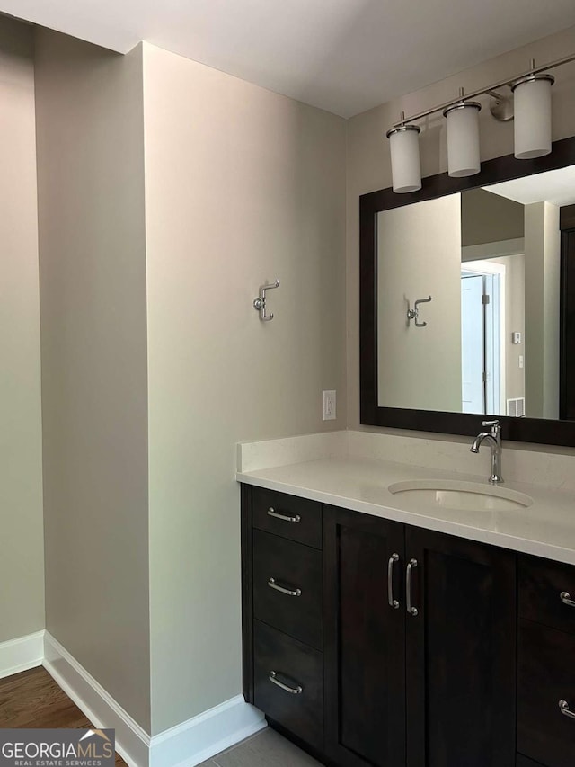 bathroom with hardwood / wood-style floors and vanity