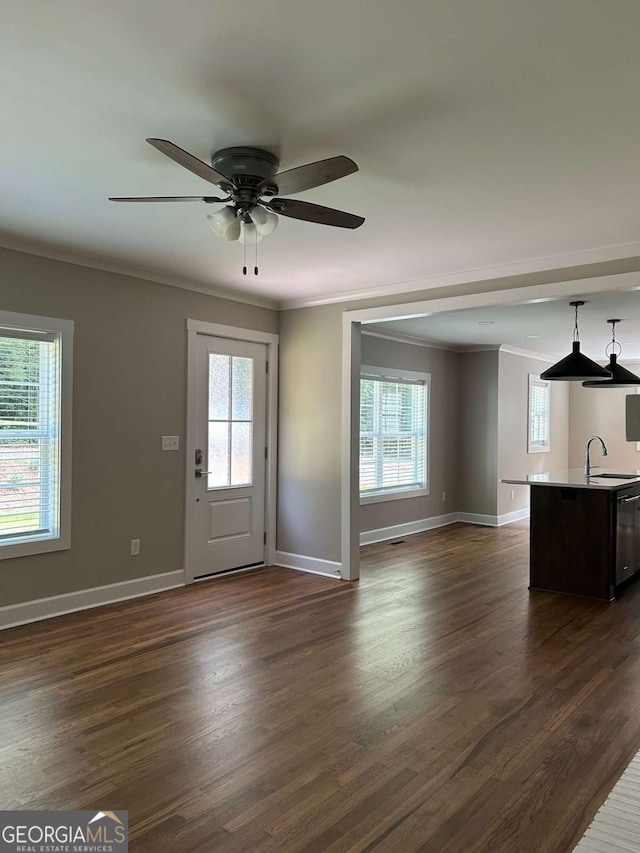 entryway with dark hardwood / wood-style floors, plenty of natural light, ceiling fan, and crown molding