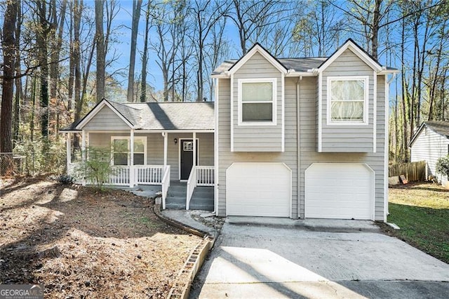 split level home with covered porch and a garage