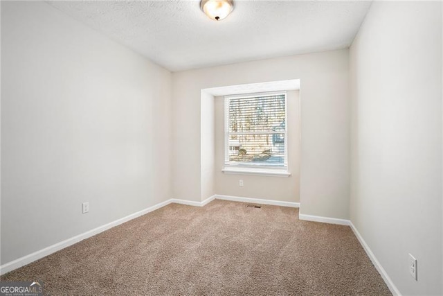 unfurnished room with light carpet