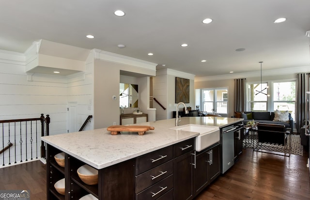 kitchen with a center island with sink, sink, stainless steel dishwasher, light stone counters, and dark hardwood / wood-style flooring