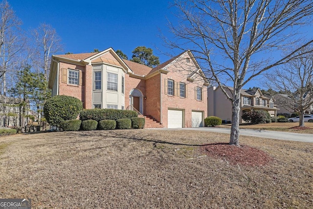 view of front of house featuring a front yard and a garage