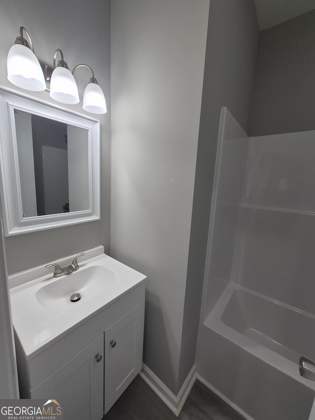 bathroom featuring vanity and  shower combination