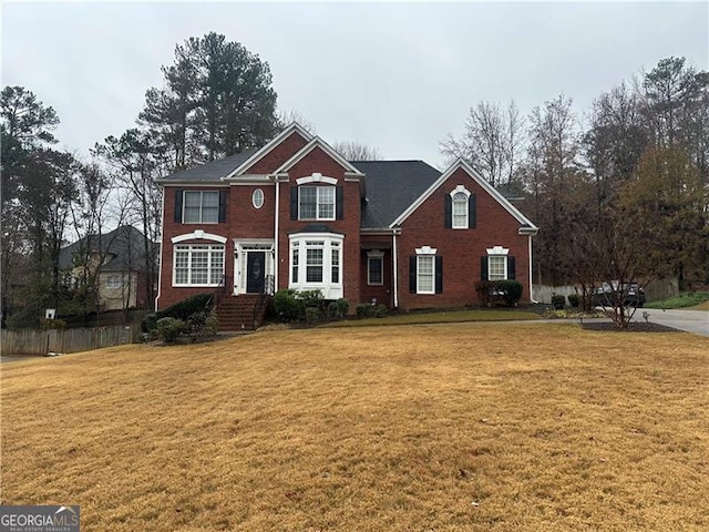 view of property featuring a front lawn