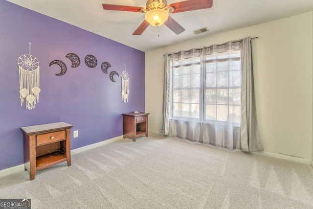 miscellaneous room with light colored carpet and ceiling fan