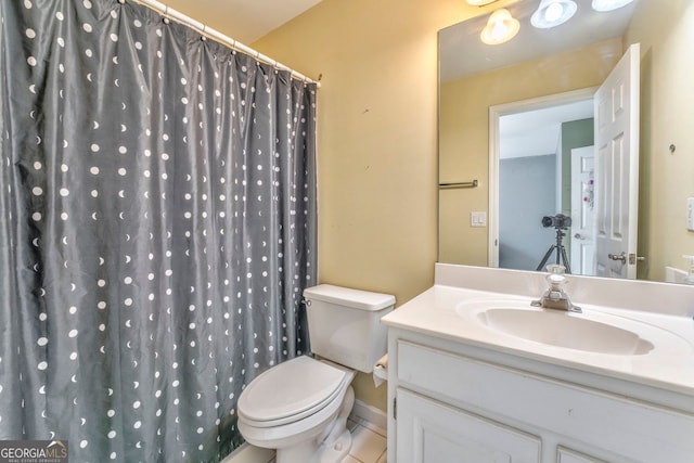 bathroom featuring tile patterned floors, a shower with curtain, toilet, and vanity