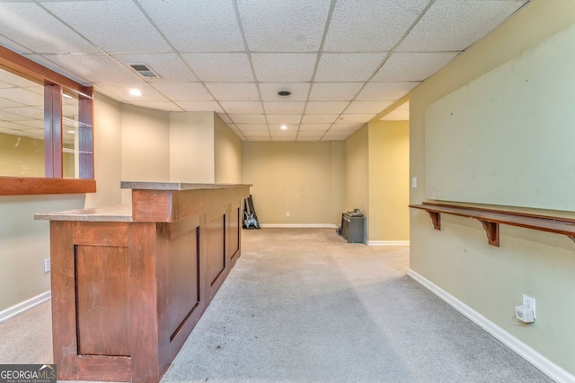 bar featuring light colored carpet and a drop ceiling