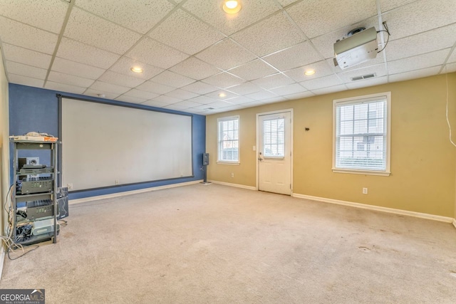 home theater room with a paneled ceiling and carpet