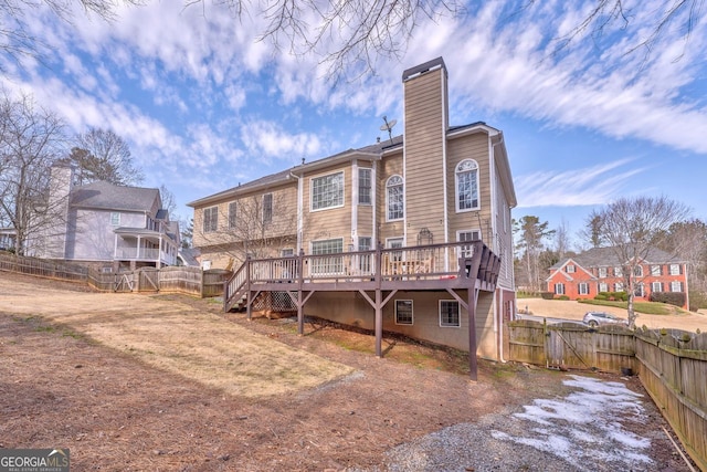 rear view of property featuring a wooden deck