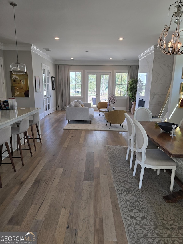 dining area with recessed lighting, visible vents, french doors, ornamental molding, and hardwood / wood-style floors