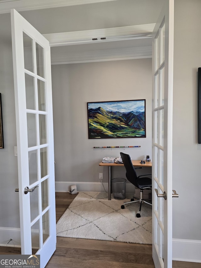 office space with baseboards, wood finished floors, and french doors