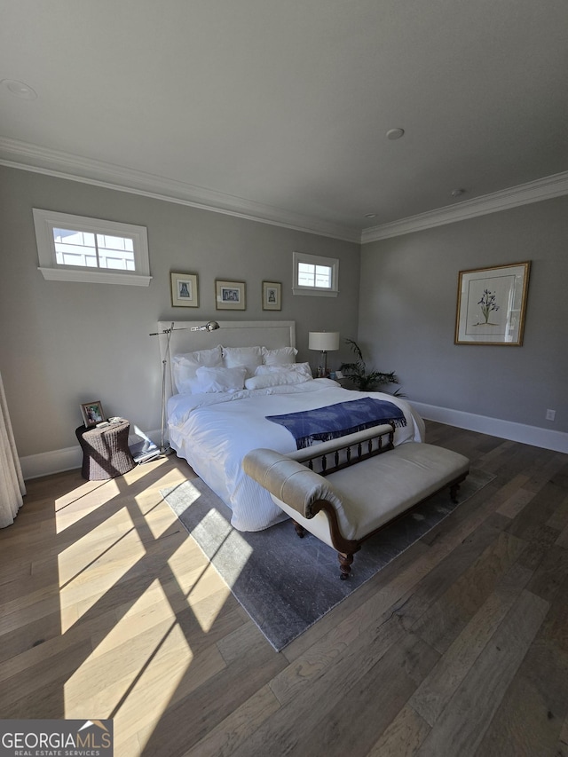 bedroom featuring ornamental molding, wood finished floors, and baseboards