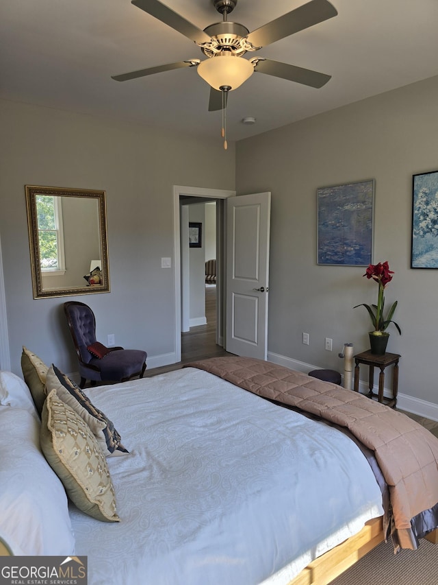 bedroom featuring a ceiling fan and baseboards