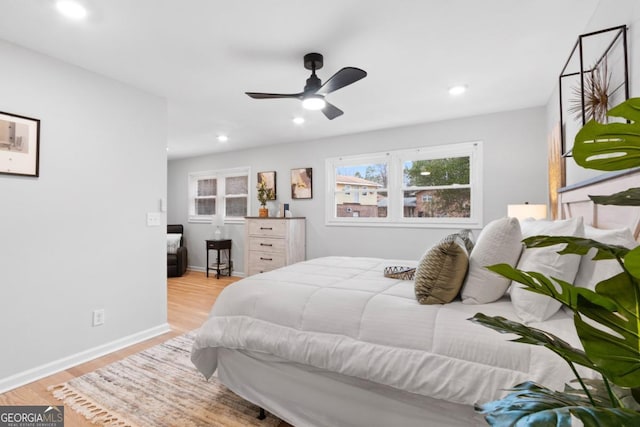 bedroom with light hardwood / wood-style floors and ceiling fan