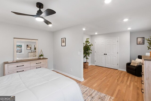 bedroom featuring a closet, ceiling fan, and light hardwood / wood-style flooring