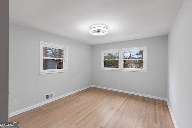 unfurnished room with light hardwood / wood-style floors