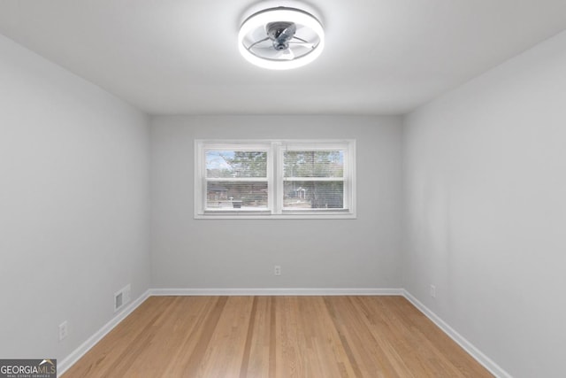 empty room featuring ceiling fan and light hardwood / wood-style flooring