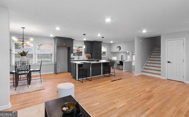 living room featuring a chandelier and light hardwood / wood-style floors