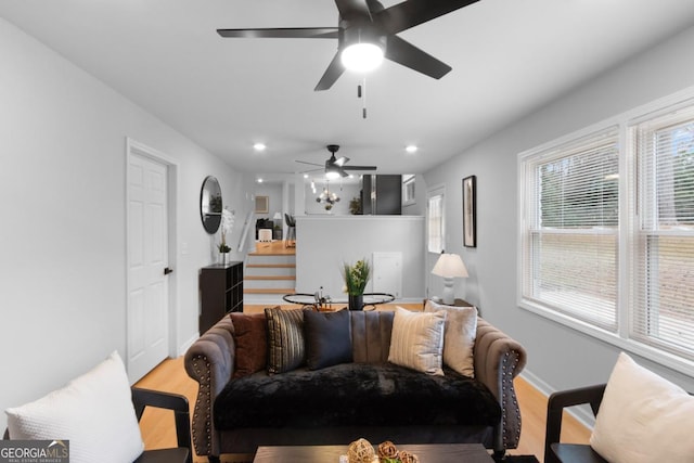 living room featuring light wood-type flooring and ceiling fan