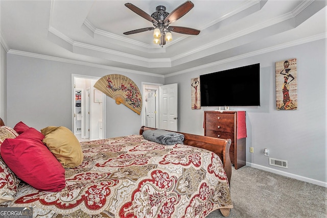 carpeted bedroom featuring ceiling fan, a raised ceiling, and crown molding