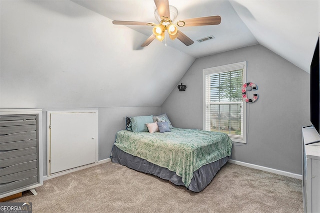 carpeted bedroom with vaulted ceiling and ceiling fan