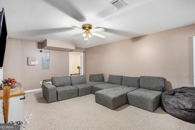 carpeted living room featuring ceiling fan and electric panel