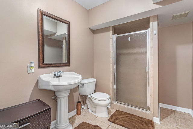 bathroom featuring tile patterned floors, sink, toilet, and walk in shower