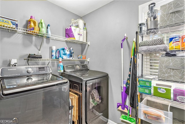 clothes washing area with separate washer and dryer