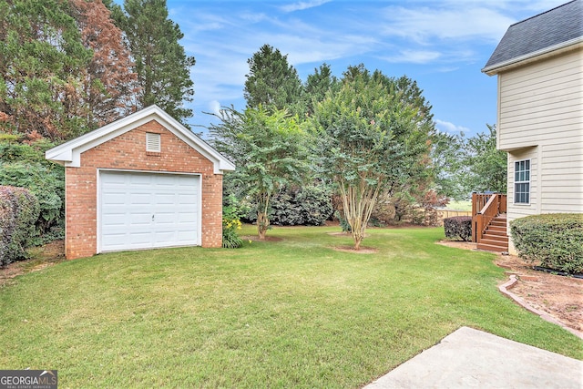 view of yard with a garage and an outdoor structure