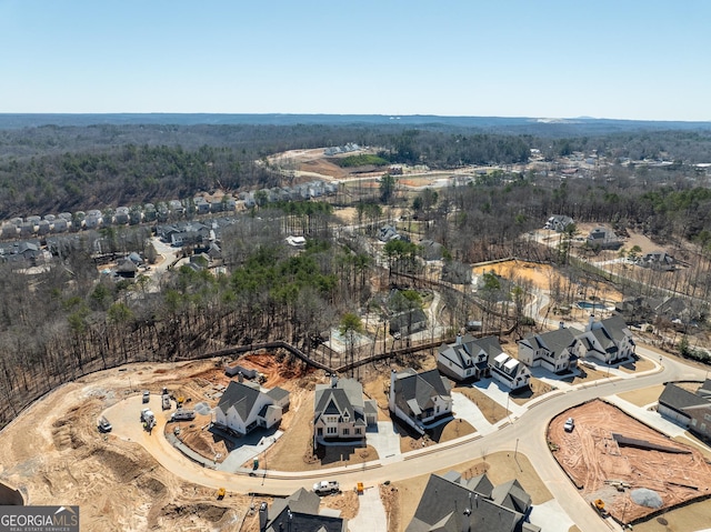 drone / aerial view featuring a forest view