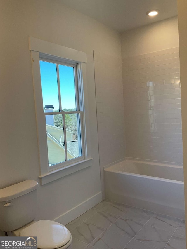 bathroom featuring toilet and shower / washtub combination