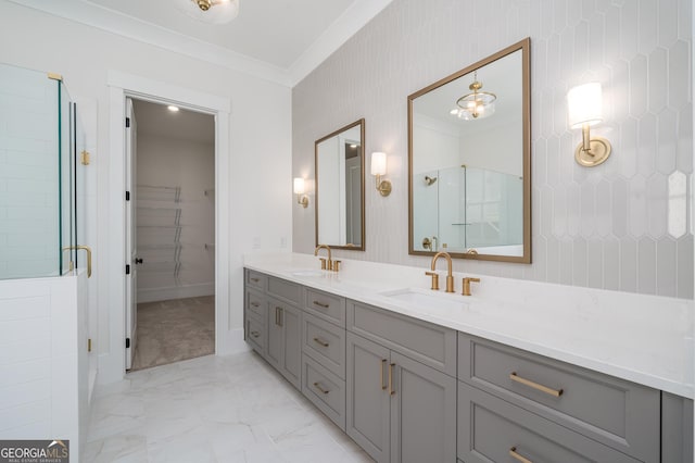 bathroom featuring ornamental molding, marble finish floor, and a sink