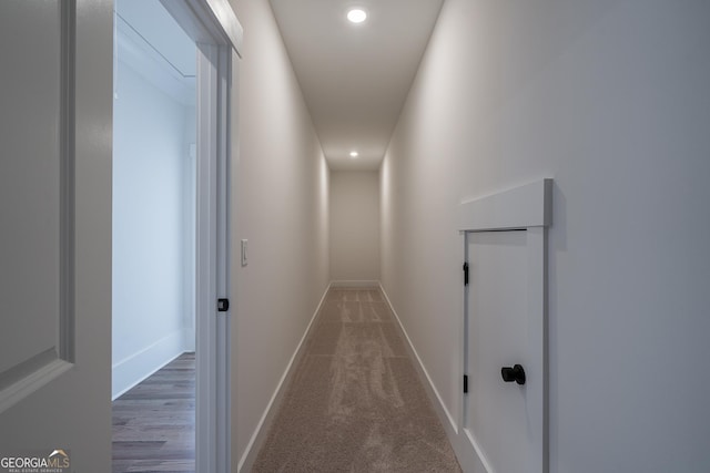 hall featuring recessed lighting and baseboards