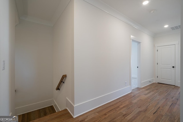 interior space with recessed lighting, wood finished floors, visible vents, baseboards, and ornamental molding