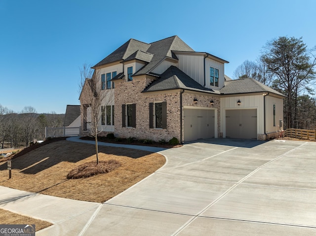 view of front of house with driveway, a garage, a shingled roof, board and batten siding, and brick siding