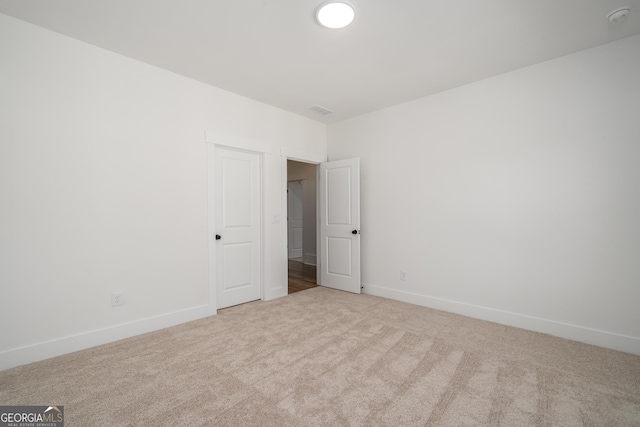 carpeted empty room with baseboards