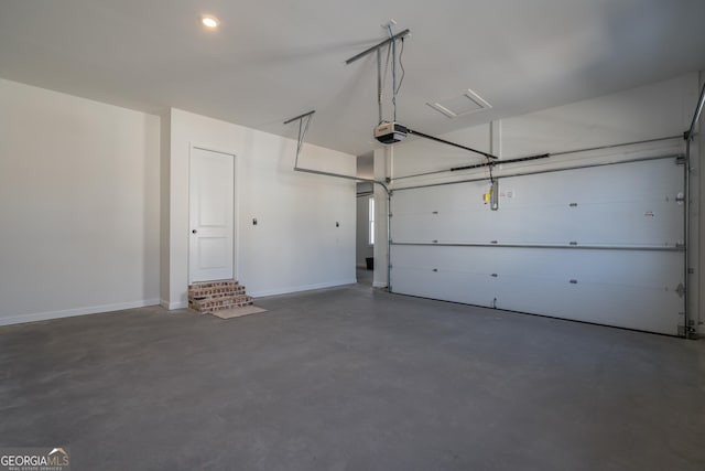 garage with a garage door opener and baseboards