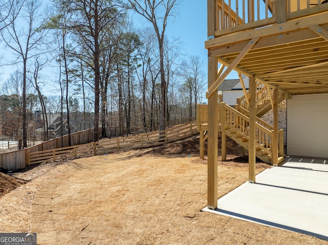 view of yard with stairs, a patio, and fence