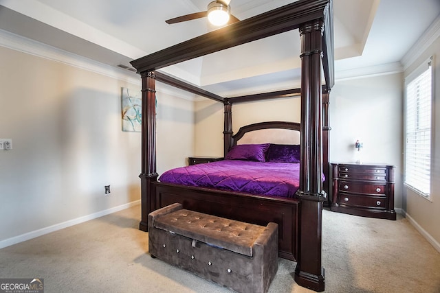 bedroom with light colored carpet, a raised ceiling, ceiling fan, crown molding, and multiple windows