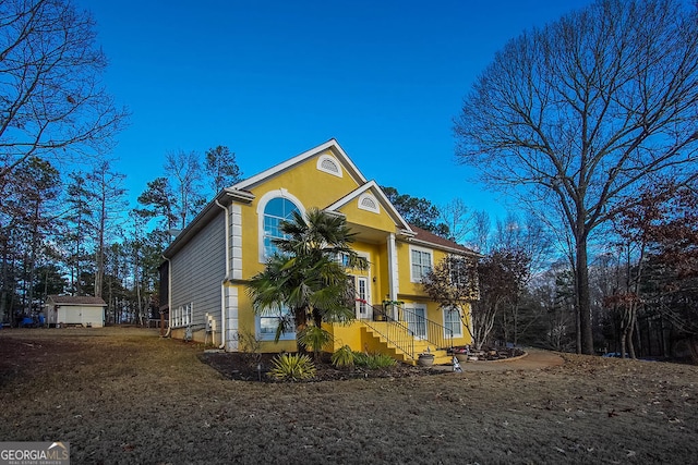 view of front of home with a storage shed