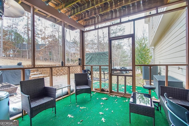 sunroom with plenty of natural light and wooden ceiling