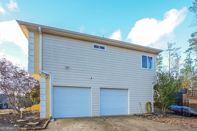 view of side of home featuring a garage